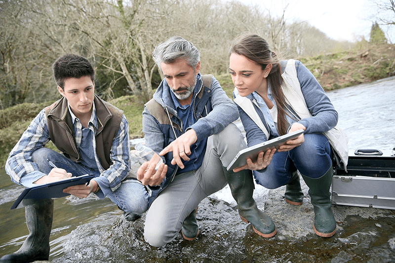 bigstock-Biologist-with-students-in-sci-86869250