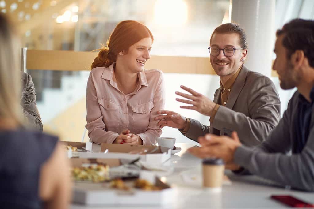 colleagues at a break.Business smiling people enjoying a meal a